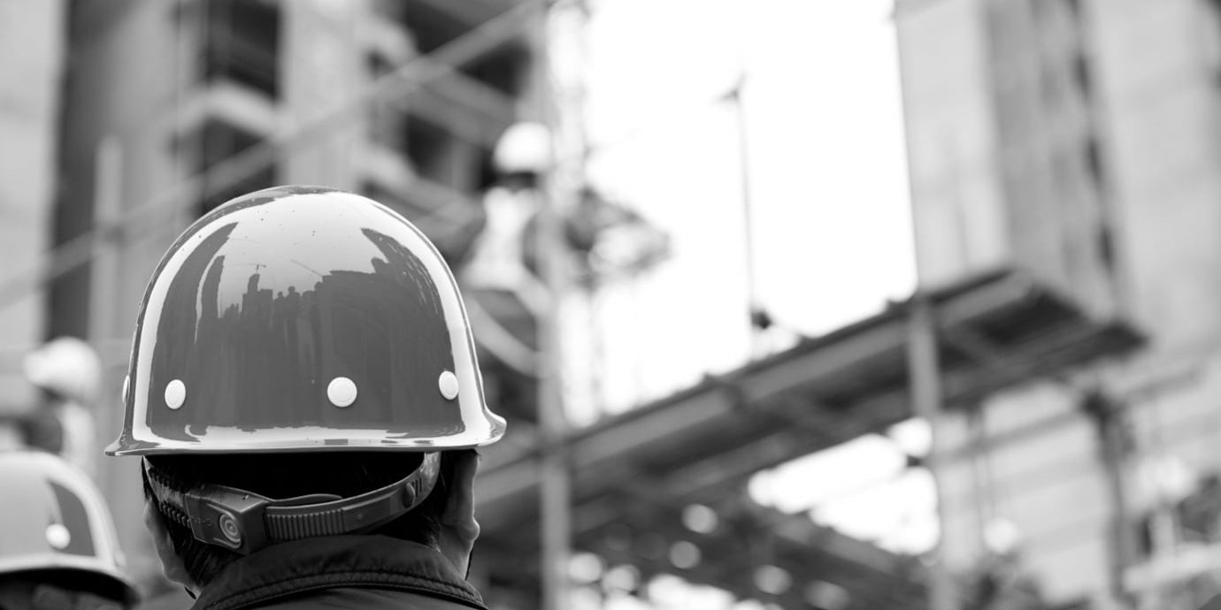Carpenter in front of construction site building in Pilbara